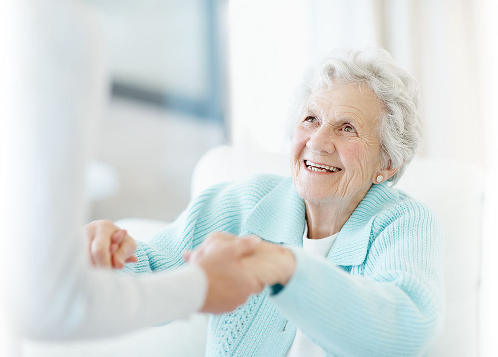 A smiling older woman spending time with a companion